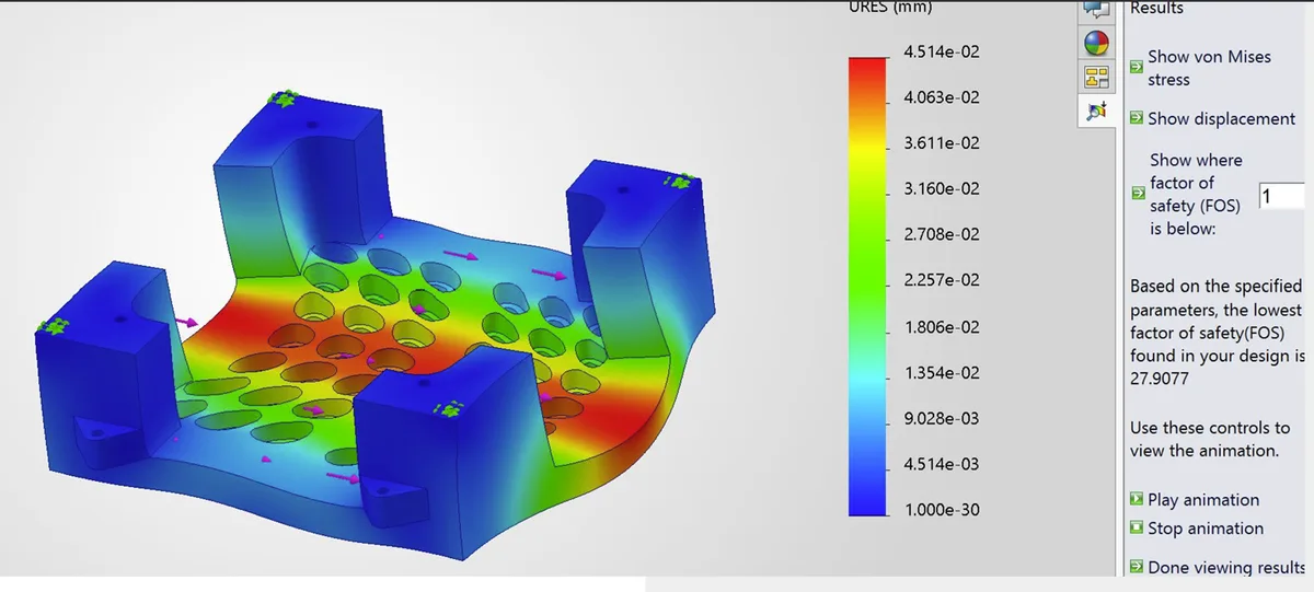 SolidWorks base FEA view showing deformation contours across the perforated support surface